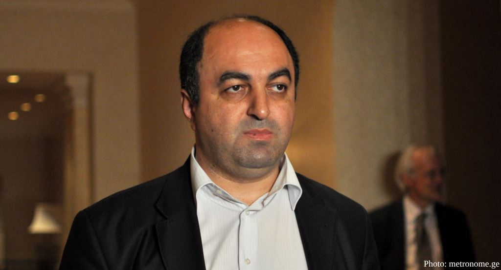 A medium shot shows a man with dark hair and a receding hairline wearing a dark suit jacket over a light-colored button-down shirt. The photo credit "Photo: metronome.ge" is visible in the bottom right corner.